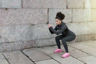 Woman doing squats on a street